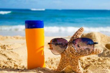A Bottle Of Reef Safe Sunscreen And Starfish On The Beach