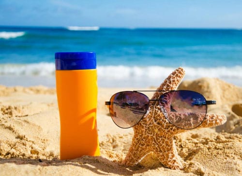 A Bottle Of Reef Safe Sunscreen And Starfish On The Beach